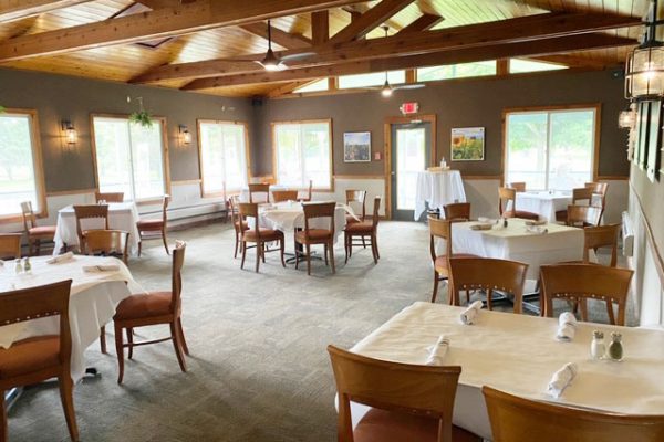 Lodge-on-the-green-dining-room-outloloking-golf-green
